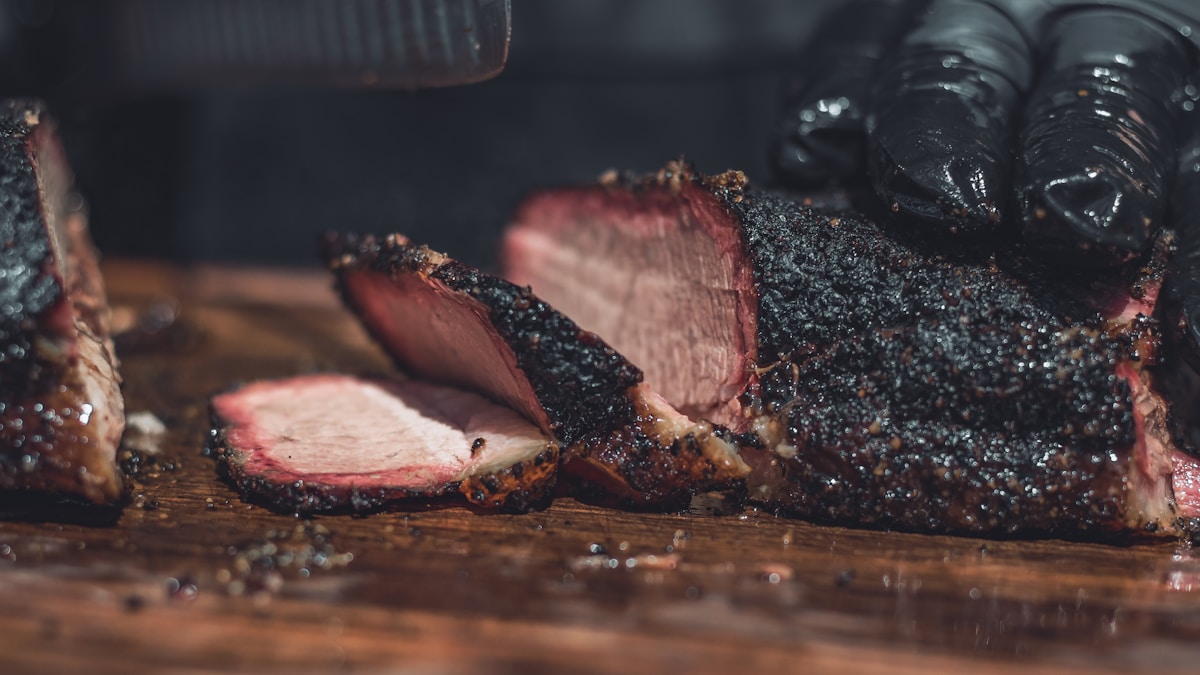 Whole Packer Brisket sliced on a wooden board